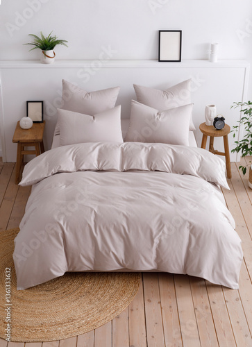 Double bed with a fluffy duvet in a beige duvet cover top view photo