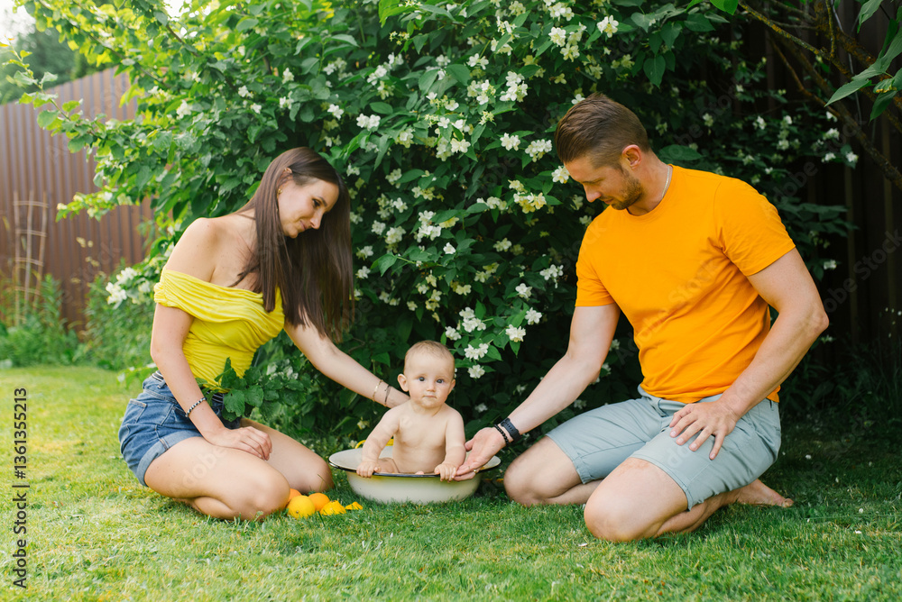 Family with Baby Playing in Water Outdoors