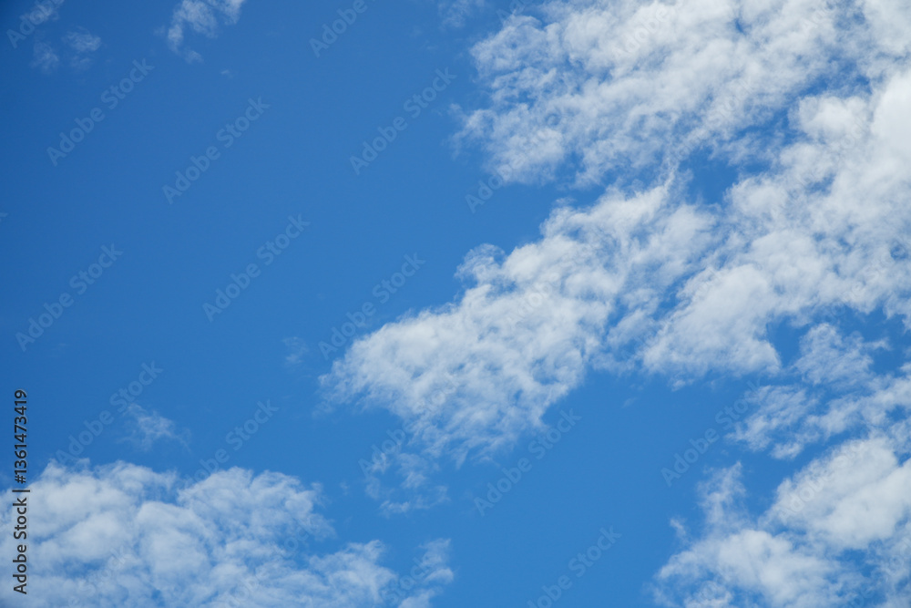 Fototapeta premium Bright Blue Sky with Soft White Clouds