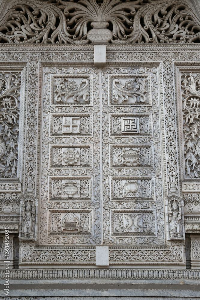 Beautiful carved door, old hindu temple in Mumbai city, Maharashtra, India. Mumbai landmark, monument. Bombay. Indian style, architecture. Heritage. Ornament, decor, decoration with hindu swastika Beautiful carved door, old hindu temple in Mumbai city, Maharashtra, India. Mumbai landmark, monument. Bombay. Indian style, architecture. Heritage. Ornament, decor, decoration with hindu swastika