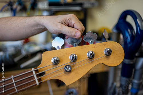 Guy tuning guitar at local shop