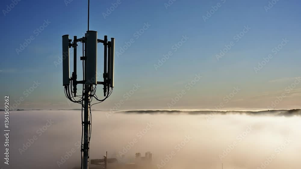 Cell tower extending above fog, telecommunications equipment for mobile network communication Cell tower extending above fog, telecommunications equipment for mobile network communication