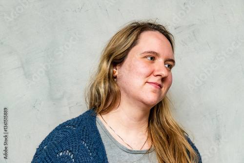 Beautiful mother smiles while enjoying a moment of peace in a modern, isolated setting