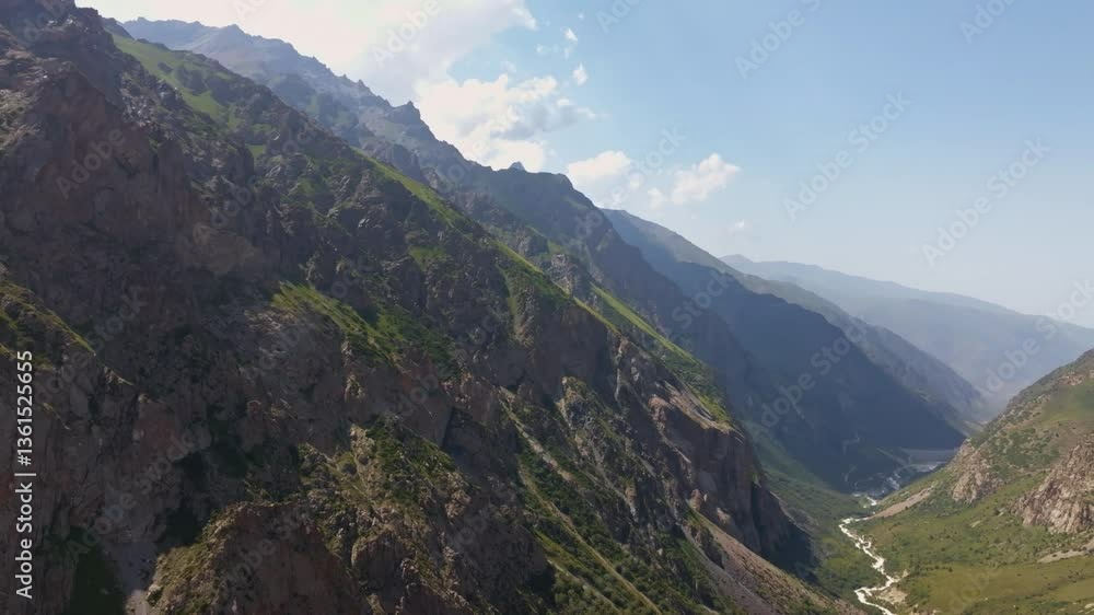 aerial shot along a rocky gorge in the Tian Shan mountains of Kyrgyzstan. Clear weather and rugged terrain. aerial shot along a rocky gorge in the Tian Shan mountains of Kyrgyzstan. Clear weather and rugged terrain.