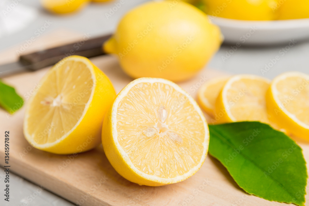 Top view with copy space for fresh and ripe lemons on cutting board. Healthy food background. Elegant background of lemon and lemon slices with squeezer colored background Top view with copy space for fresh and ripe lemons on cutting board. Healthy food background. Elegant background of lemon and lemon slices with squeezer colored background