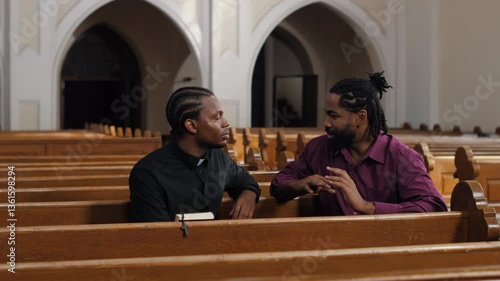 Priest listening to a man's confession in church