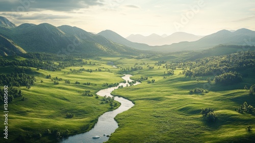 Serene river winding through lush green valley with mountainous backdrop at sunset