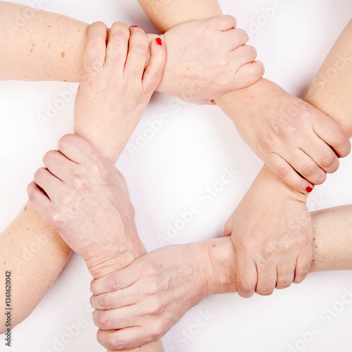 six hands form a circle by holding each other's wrist, white background