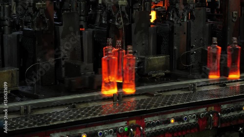 Robotic whiskey bottle production line. Glass bottle for alcohol.