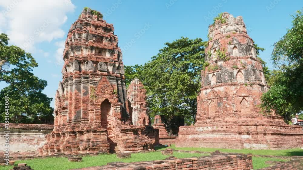 Stunning sunlit view of Wat Maha That traditional Buddhist temples, admiring ancient brick architecture at the famous Thailand landmark. Spiritual and cultural tourist attraction. Stunning sunlit view of Wat Maha That traditional Buddhist temples, admiring ancient brick architecture at the famous Thailand landmark. Spiritual and cultural tourist attraction.