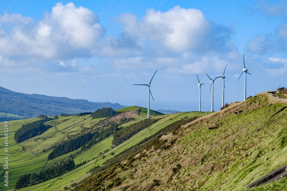 Picturesque view of wind turbines standing tall on the rolling green hills of Terceira, showcasing the island's commitment to renewable energy. Wind energy. Turbines on top of a mountain