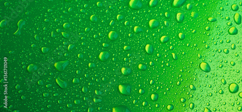 green background with texture of rain drops on a metal surface closeup