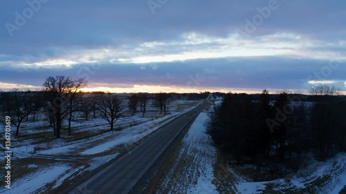 Rural Iowa Winter Blizzard Landscape at Sunset: 4K Drone Footage of Snow-Covered Fields and Farmland in the USA from a Birds-Eye View