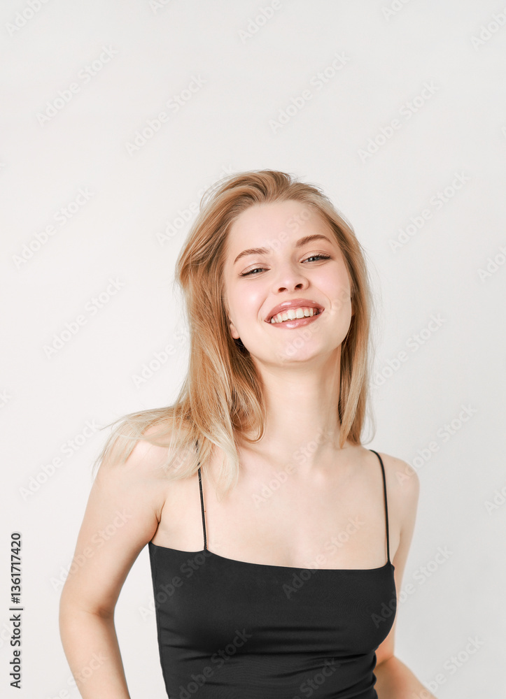 Portrait of a smiling beautiful blonde in a black top. Portrait of a smiling beautiful blonde in a black top.