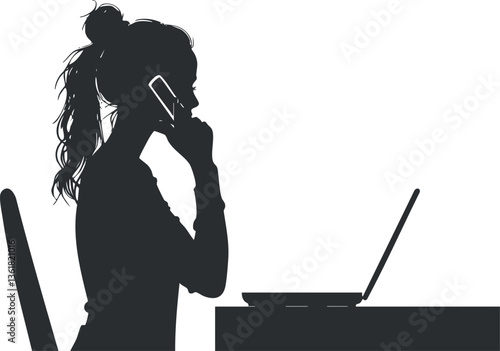 Silhouette of a woman on a phone call while using a laptop at a desk.