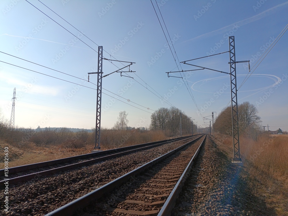 Two way railroad tracks in countryside. Two railway tracks. Sunny day. Countryside. Fields and trees. Two way railroad tracks in countryside. Two railway tracks. Sunny day. Countryside. Fields and trees.