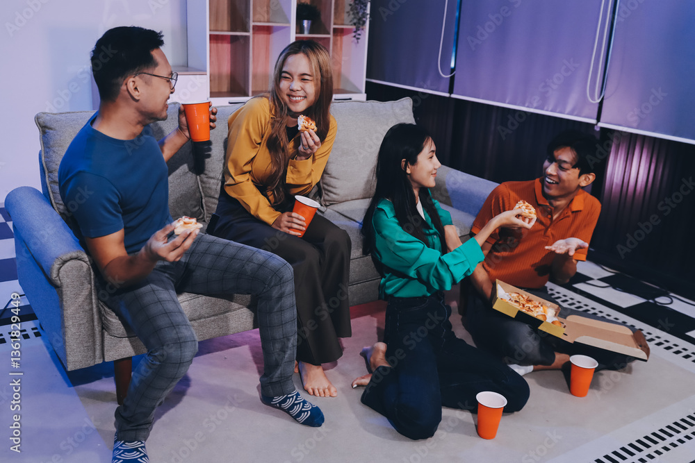 Fototapeta premium Happy young friends group having lunch at home. Asia family party eating pizza food and laughing enjoying meal while sitting at dining table together at house. Celebration holiday and togetherness.
