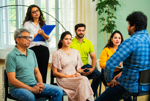 Fotografie Indian Business manager guiding his team of young professionals in a cozy creati
