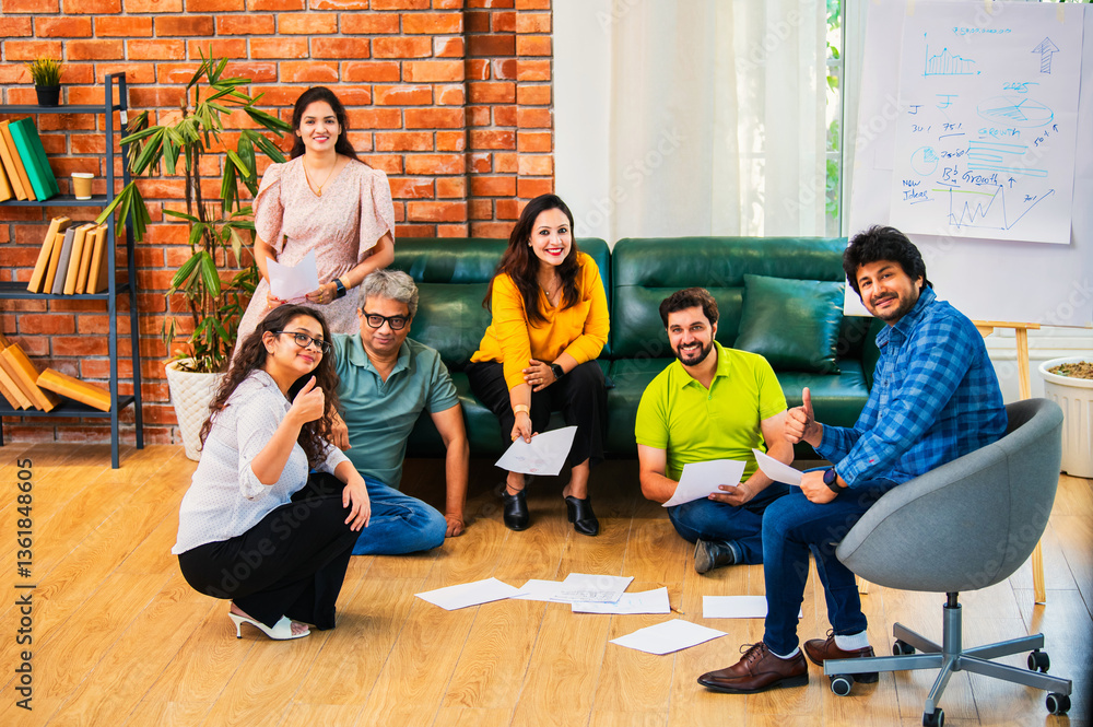 Fototapeta premium Indian Young professionals discussing ideas, planning a business project with documents in office