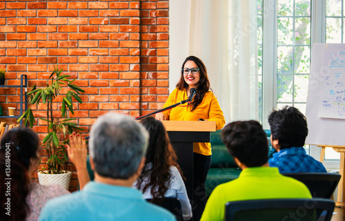 Картината върху платно Indian Asian Confident life coach addressing entrepreneurs at a business event w