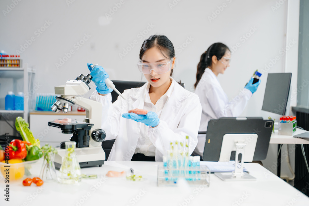 Food scientists in lab coats, testing samples, and analyzing food safety and quality in a laboratory
