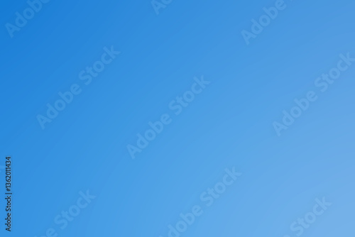 Fototapeta Naklejka Na Ścianę i Meble -  A clear blue sky with absolutely no clouds visible in it