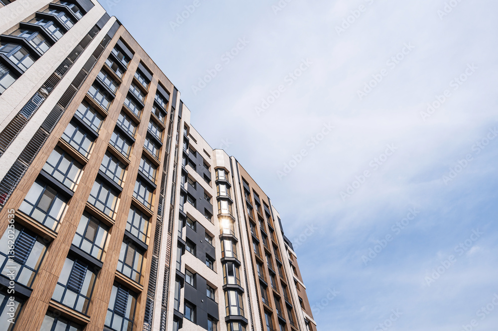The facade of a new apartment building against the sky . The facade of a new apartment building against the sky .