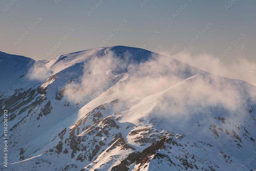 Snow-covered peaks of the Tatra Mountains with Kasprowy Wierch in winter. Stunning alpine scenery, perfect for skiing, hiking, and photography. Cold, crisp air and breathtaking views