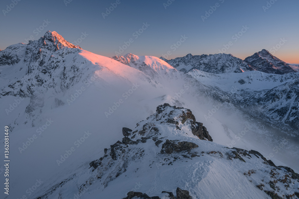 Snow-covered peaks of the Tatra Mountains with Kasprowy Wierch in winter. Stunning alpine scenery, perfect for skiing, hiking, and photography. Cold, crisp air and breathtaking views