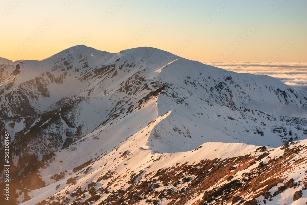 Snow-covered peaks of the Tatra Mountains with Kasprowy Wierch in winter. Stunning alpine scenery, perfect for skiing, hiking, and photography. Cold, crisp air and breathtaking views