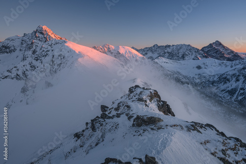 Obraz na płótnie Snow-covered peaks of the Tatra Mountains with Kasprowy Wierch in winter. Stunning alpine scenery, perfect for skiing, hiking, and photography. Cold, crisp air and breathtaking views w salonie