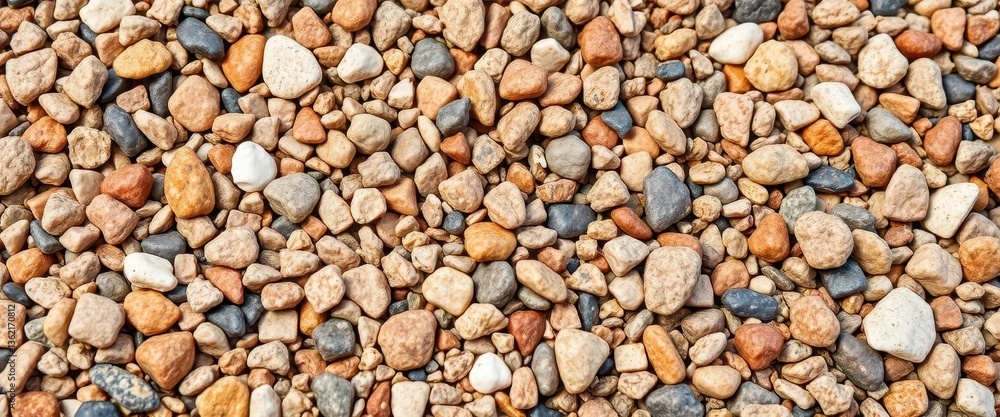 Close-up of coarse granite gravel, showing varied colors and textures, pebbles, hard Close-up of coarse granite gravel, showing varied colors and textures, pebbles, hard