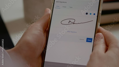 Professional businesswoman digitally signing legal document using smartphone touchscreen, verifying electronic agreement with confident finger tapping