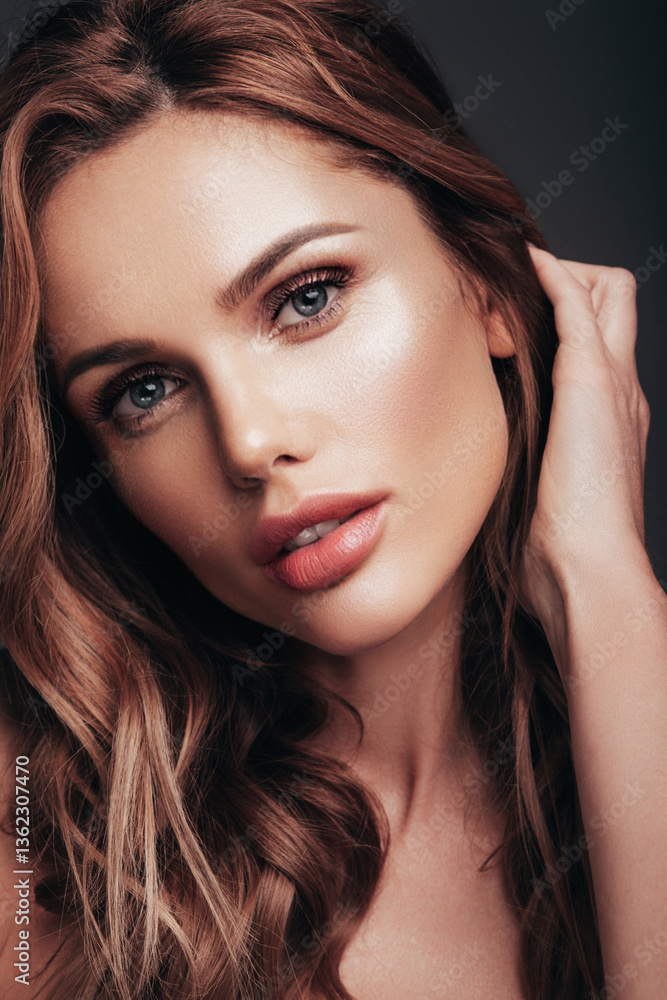 Fototapeta premium Fashion beauty portrait of young brunette woman with evening stylish makeup and perfect clean skin. Sexy model with curly hairstyle posing in studio