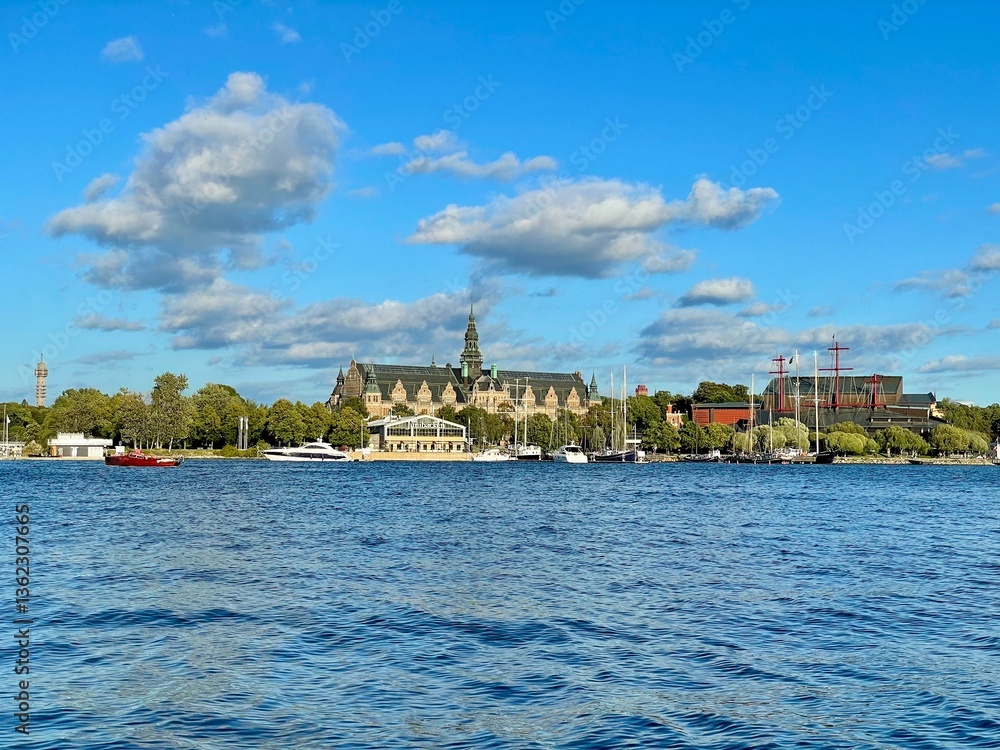 Obraz premium View of Stockholm from a boat, Sweden. View of Stockholm from the water features an elegant historical building, likely the Nordiska Museum, with its intricate roof and spire.