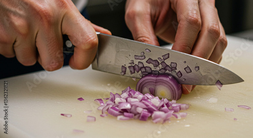 Close Up Of A Person Cutting A Red Onion With A Silver Knife On A White Cutting Board