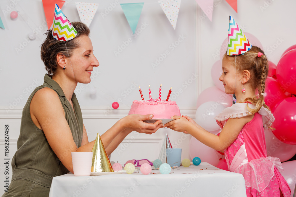 Sweet birthday moment as mom gives pink cake to her daughter