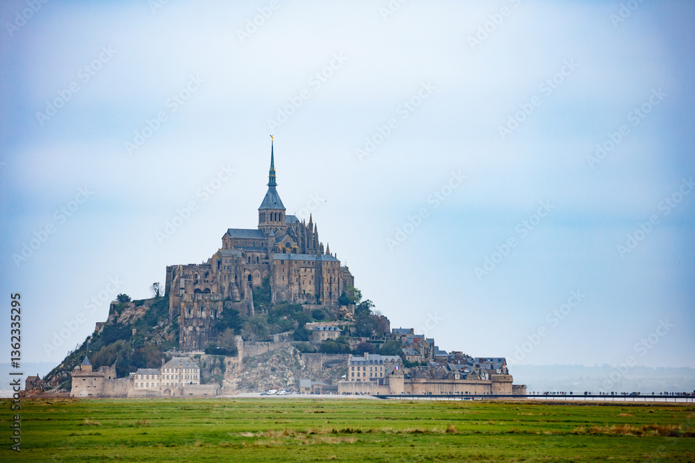 Ancient castle Mont Saint Michel, in autumn foggy day, France