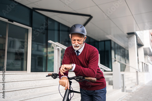 Senior Businessman Checking Time While Commuting on a Bicycle