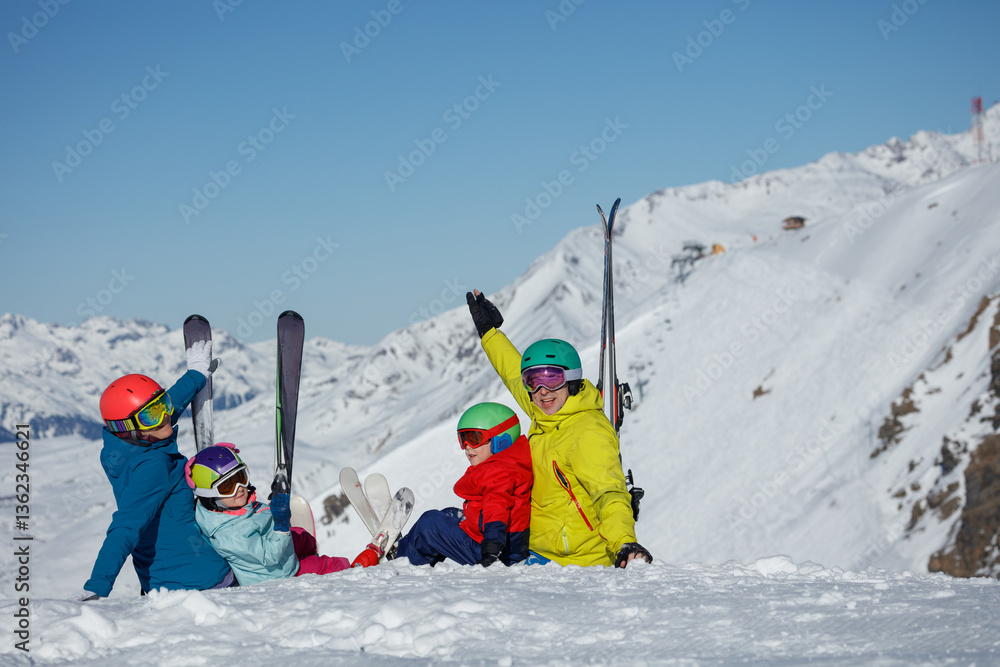 Colorful family on snowy slope prepares for a skiing adventure
