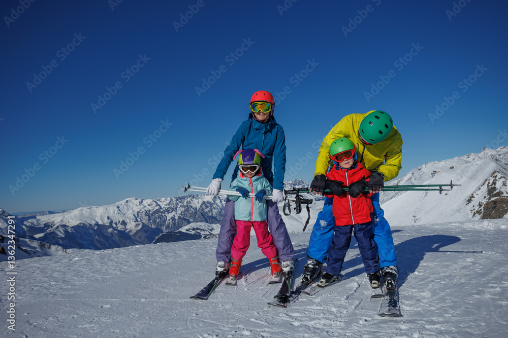 Family bonding fun on skis amidst breathtaking mountain scenery