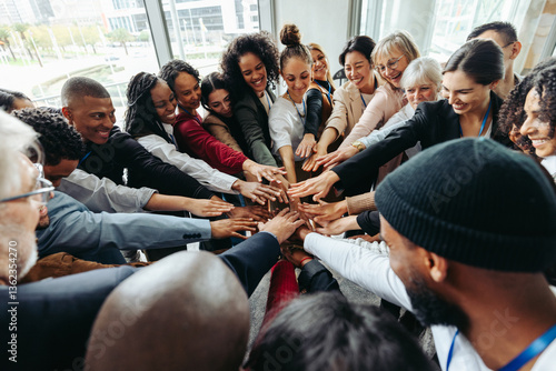 Konstfotografi Corporate team with hands united celebrating success and teamwork in modern offi