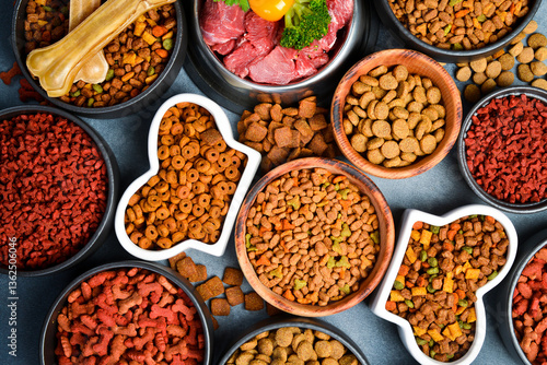 Dry pet food with natural ingredients. Raw meat in a bowl for pets. A set of different fodder and food for dogs or cats.