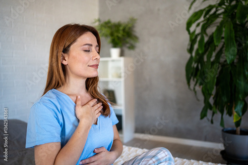 Slika na platnu Serene woman practicing deep breathing exercise at home