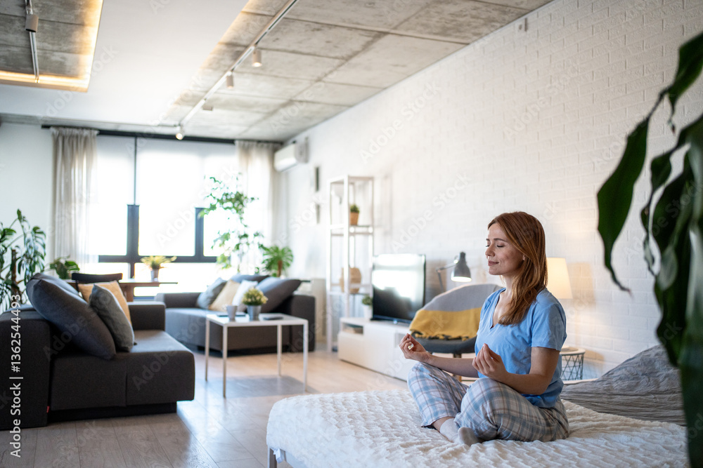 Serene woman meditating on bed in modern apartment, embracing mindfulness and inner peace Serene woman meditating on bed in modern apartment, embracing mindfulness and inner peace