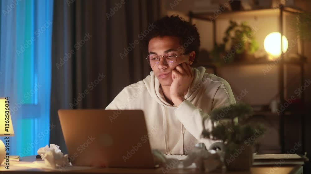 Overjoyed young man reacting emotionally to an unexpected positive message while sitting at laptop at home in the evening experiencing pure happiness and disbelief after reading great news Overjoyed young man reacting emotionally to an unexpected positive message while sitting at laptop at home in the evening experiencing pure happiness and disbelief after reading great news