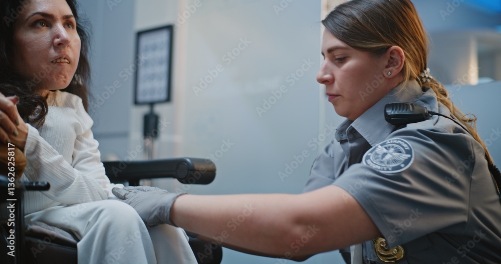 Security Checkpoint: Close Up of Female TSA Officer Checking Woman with Disability in Airport Terminal. Passenger Screening Procedures for Boarding Plane Flight. Traveler in Wheelchair Going on Trip. Security Checkpoint: Close Up of Female TSA Officer Checking Woman with Disability in Airport Terminal. Passenger Screening Procedures for Boarding Plane Flight. Traveler in Wheelchair Going on Trip.