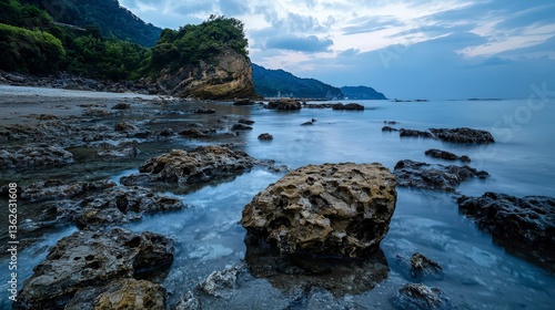 Coastal sunset reflection rocky shore landscape photography serene environment wide angle nature's beauty
