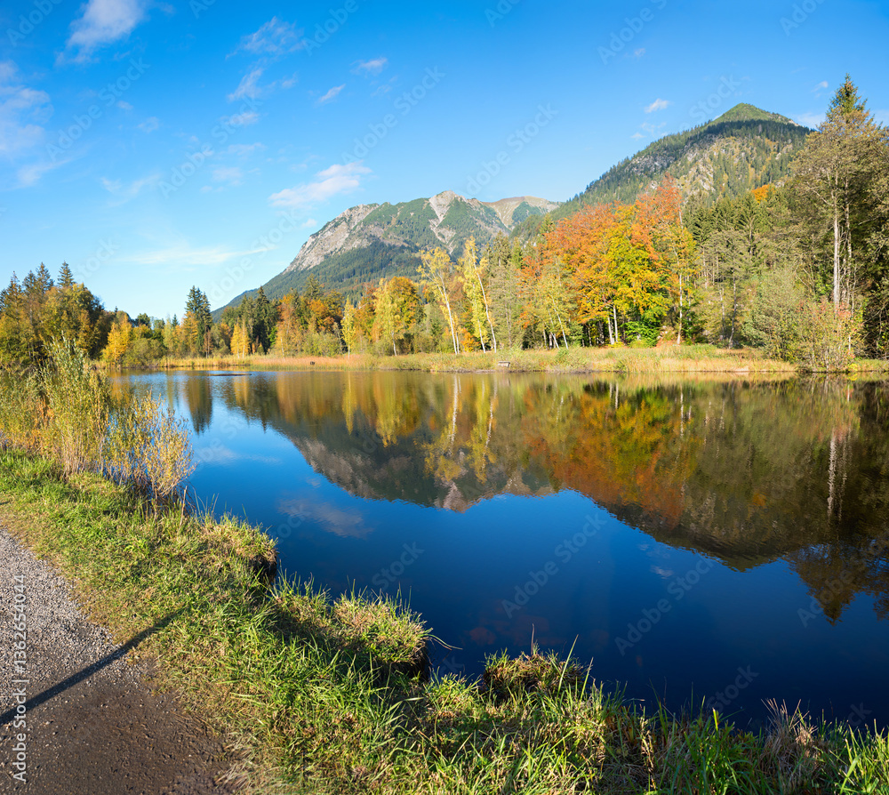 lake Moorweiher near Oberstdorf, colorful trees reflecting in the water. allgau landscape