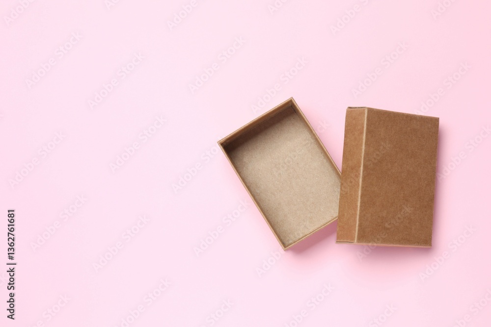 Open cardboard box on pink background Open cardboard box on pink background